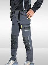Load image into Gallery viewer, Person wearing gray work pants with multiple pockets and zippers on a white backgroundmens cargo work trousers
mens workwear trousers
elasticated waist work trousers